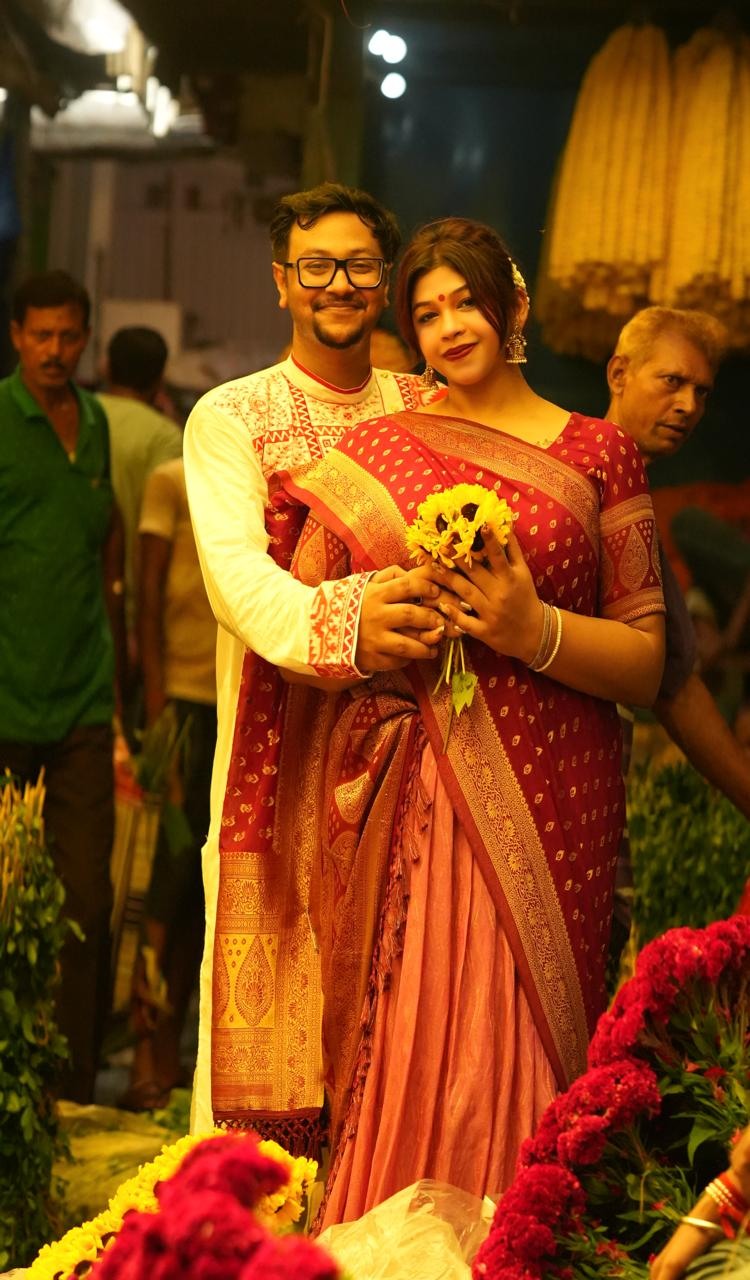 Soham and Tania among the flowers of Kolkata in traditional dress